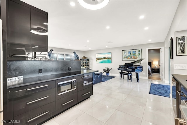 13 Pelican St W, Naples, FL 34113 - kitchen with light tile patterned flooring and decorative backsplash