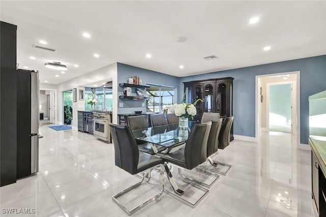 13 Pelican St W, Naples, FL 34113 - tiled dining area featuring a barn door