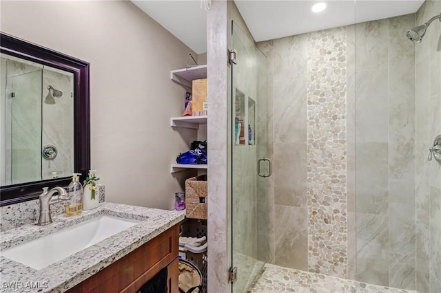 bathroom featuring vanity and a shower with shower door