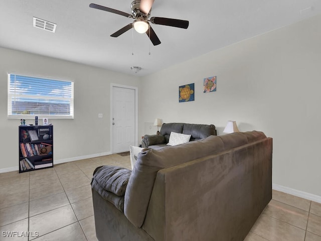 living room with light tile patterned floors and ceiling fan