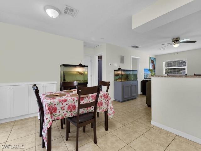 tiled dining space with ceiling fan