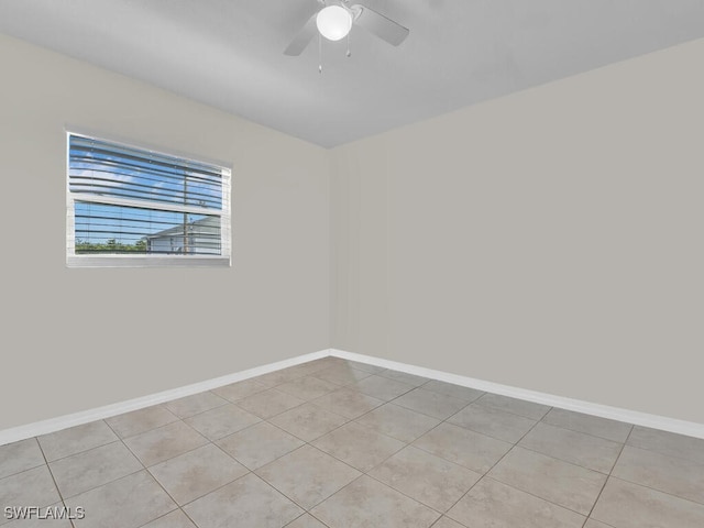 spare room with light tile patterned floors and ceiling fan