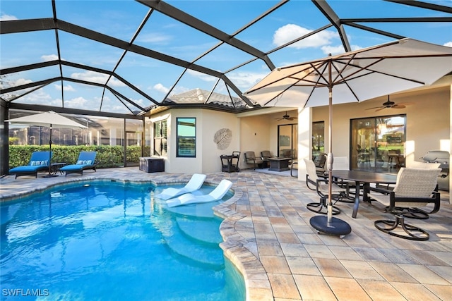 view of swimming pool with a patio, a lanai, and ceiling fan