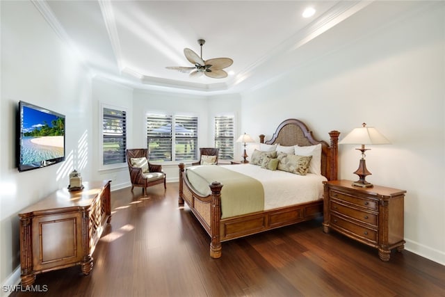 bedroom featuring crown molding, ceiling fan, dark hardwood / wood-style floors, and a raised ceiling