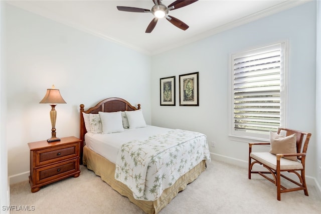 bedroom featuring crown molding, light colored carpet, and ceiling fan