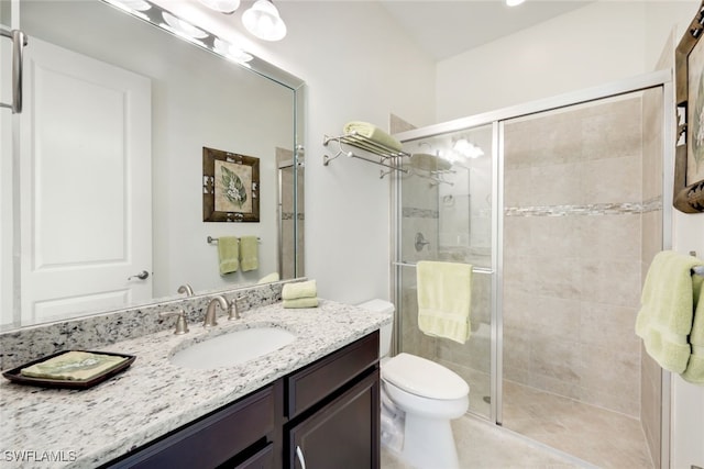 bathroom featuring vanity, toilet, and walk in shower