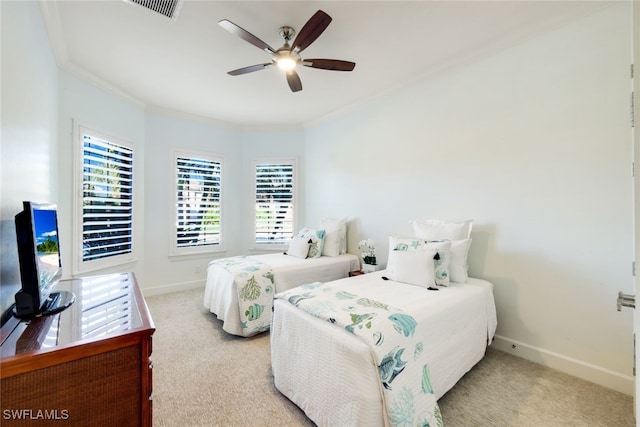 bedroom with ceiling fan, light colored carpet, and ornamental molding