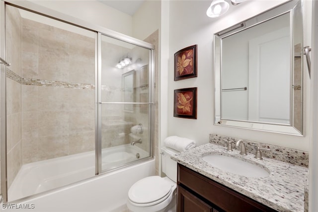 full bathroom with vanity, enclosed tub / shower combo, and toilet