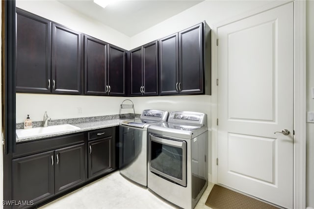 laundry room with cabinets, separate washer and dryer, and sink