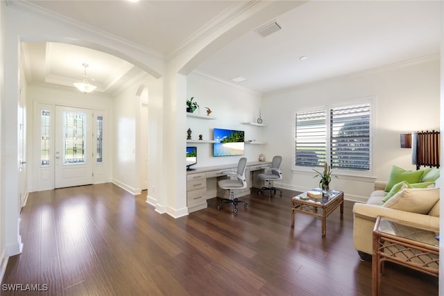 interior space featuring built in desk, ornamental molding, and dark hardwood / wood-style floors