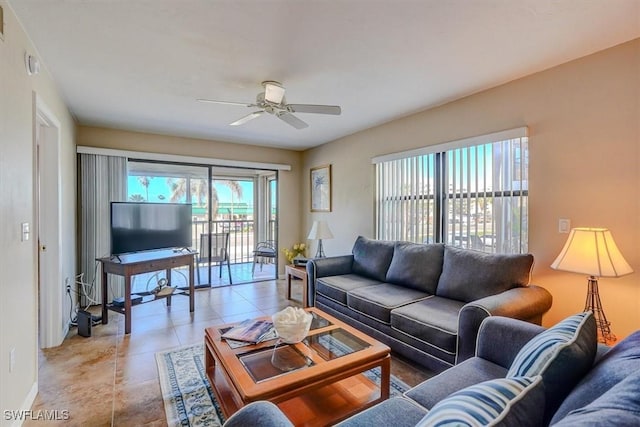 tiled living room with ceiling fan