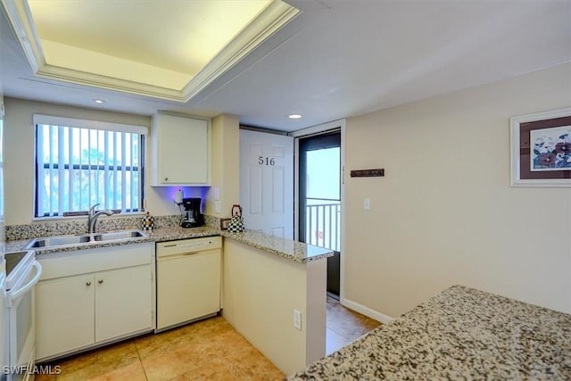 kitchen with sink, range, white dishwasher, a tray ceiling, and kitchen peninsula