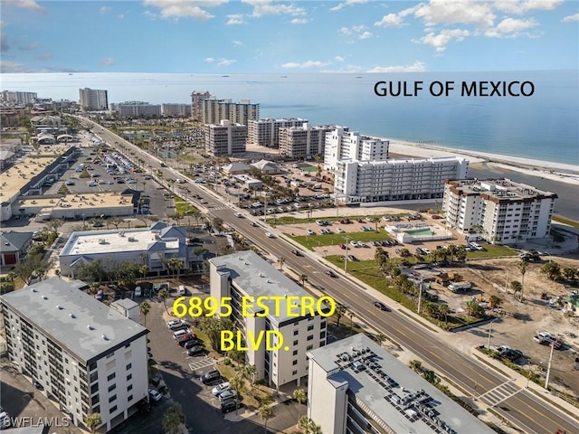 bird's eye view with a water view and a beach view