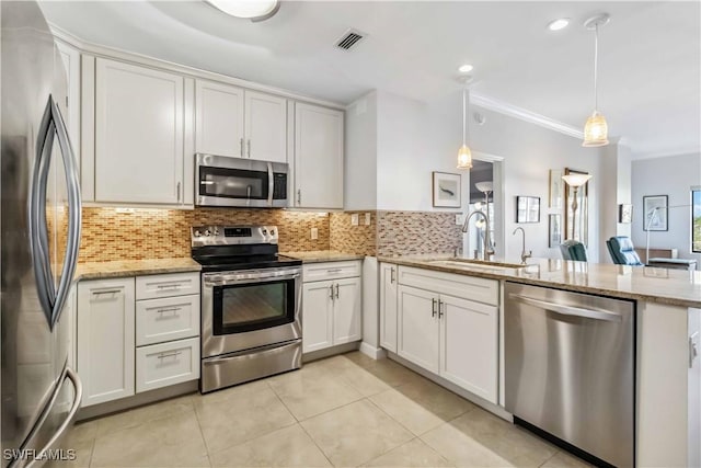 kitchen featuring pendant lighting, stainless steel appliances, and white cabinets