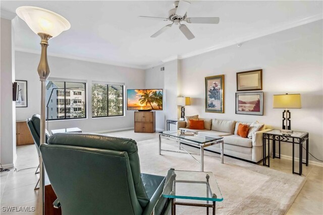 living room with ceiling fan and ornamental molding