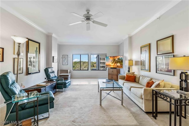 living room featuring ceiling fan, light colored carpet, and ornamental molding