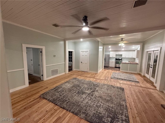 unfurnished living room featuring ornamental molding, ceiling fan, wood ceiling, light hardwood / wood-style floors, and french doors