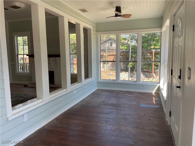 unfurnished sunroom featuring plenty of natural light and ceiling fan