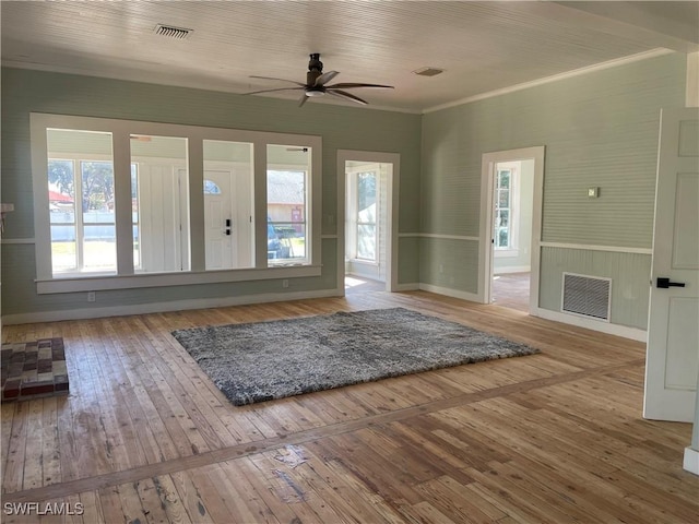 interior space featuring hardwood / wood-style floors, ornamental molding, and ceiling fan