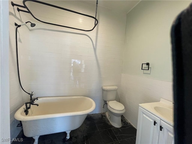 bathroom featuring vanity, tile walls, a tub, and toilet