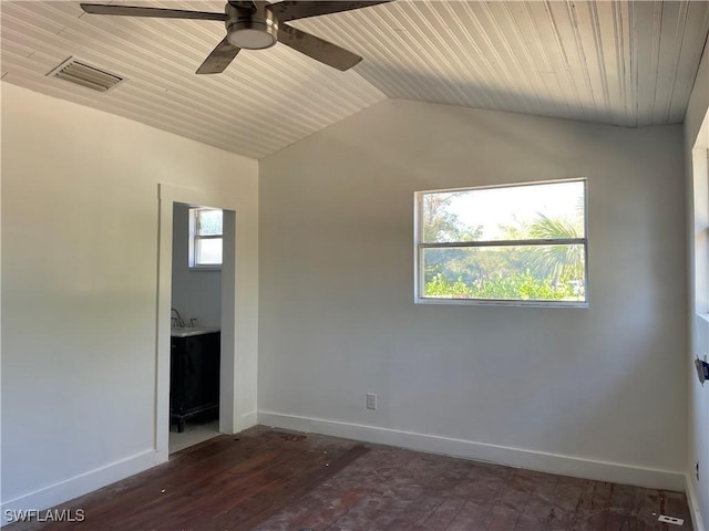 spare room featuring vaulted ceiling, dark wood-type flooring, a wealth of natural light, and wood ceiling