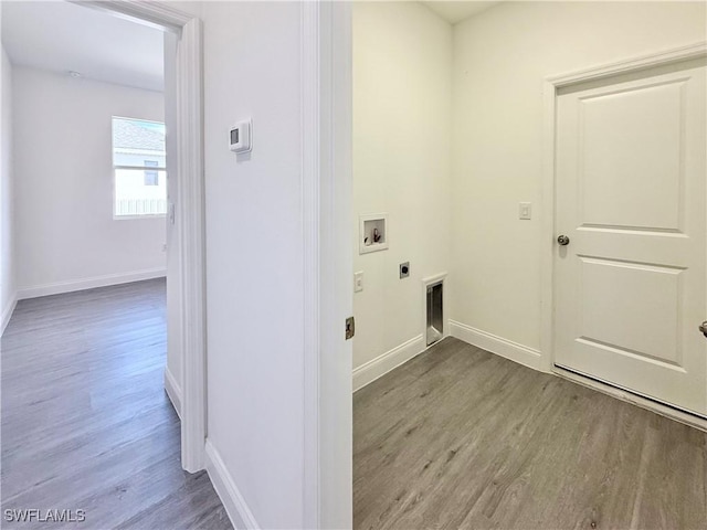 laundry area with electric dryer hookup, hookup for a washing machine, and light wood-type flooring