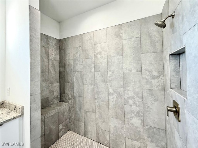 bathroom featuring vanity and a tile shower