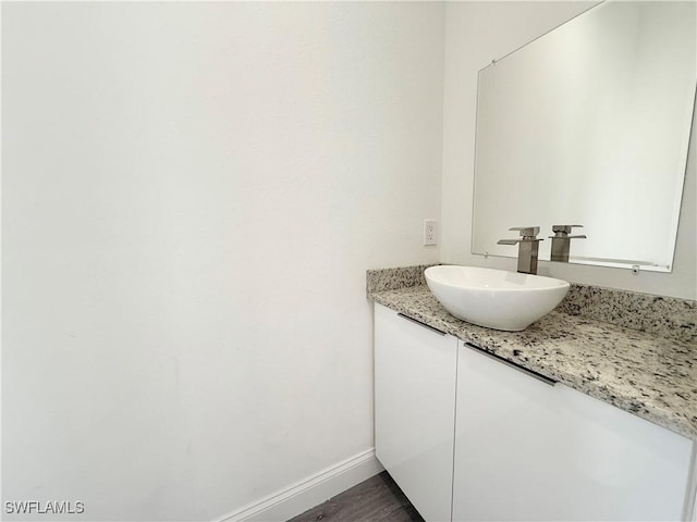 bathroom featuring hardwood / wood-style flooring and vanity