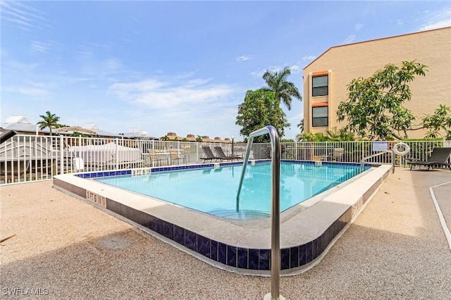 view of swimming pool with a patio