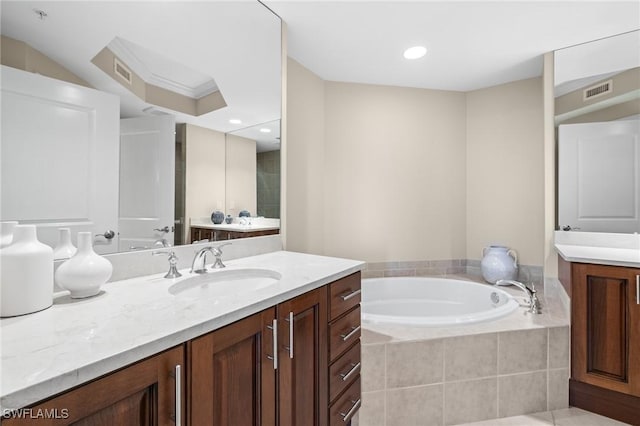 bathroom featuring vanity and tiled bath