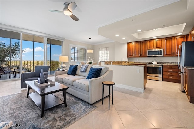 living room featuring crown molding, ceiling fan, and light tile patterned floors