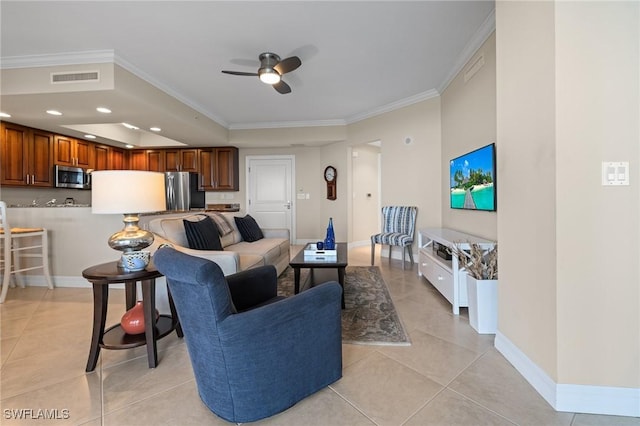 tiled living room with ornamental molding and ceiling fan