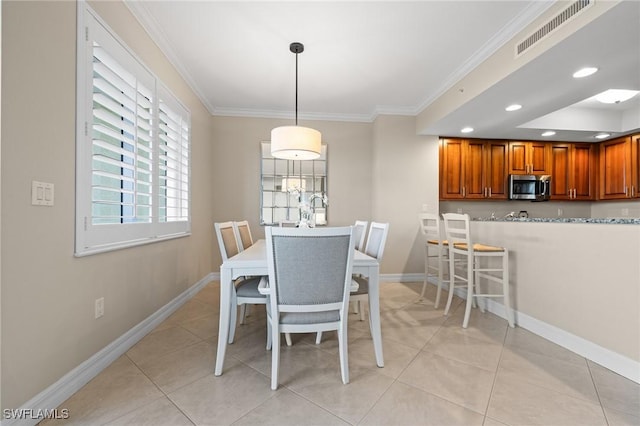 tiled dining room with ornamental molding