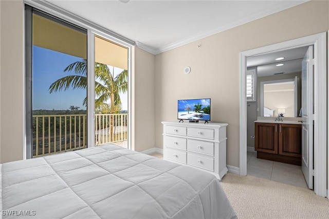 bedroom with connected bathroom, sink, ornamental molding, light colored carpet, and access to exterior