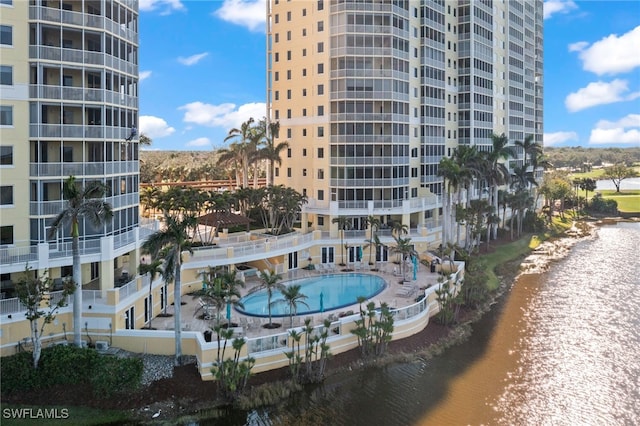 exterior space with a water view and a community pool