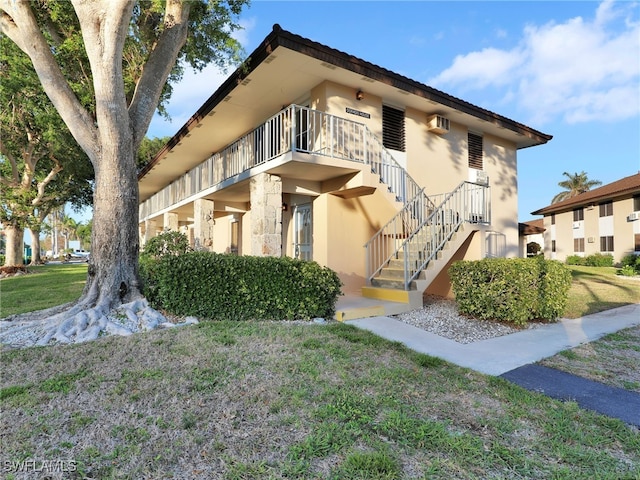 view of side of property with a lawn