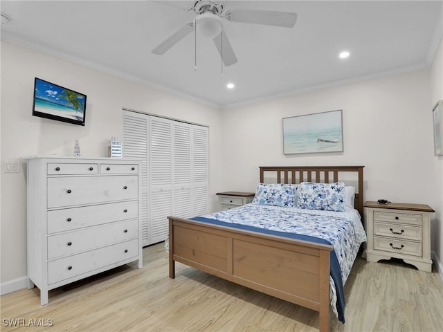 bedroom featuring crown molding, ceiling fan, a closet, and light wood-type flooring