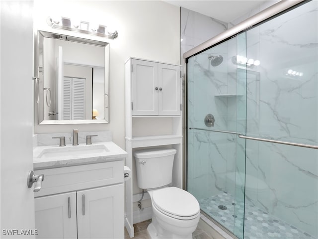 bathroom with toilet, vanity, and walk in shower