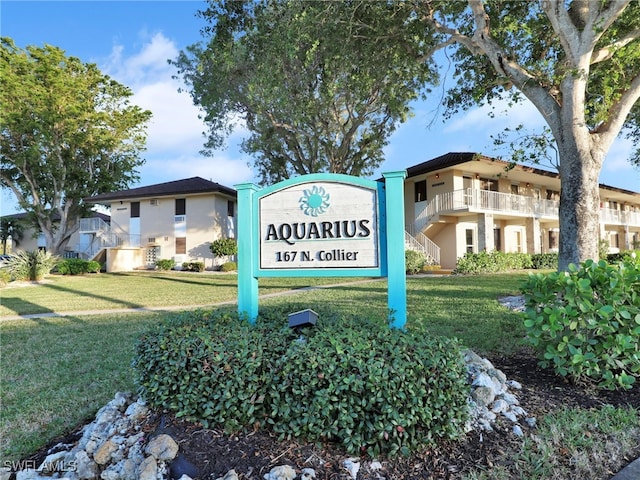 community sign featuring a yard