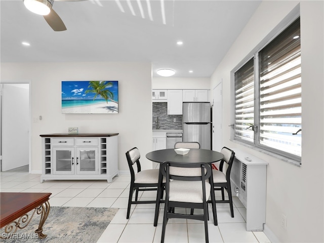 dining room featuring light tile patterned flooring, sink, and ceiling fan