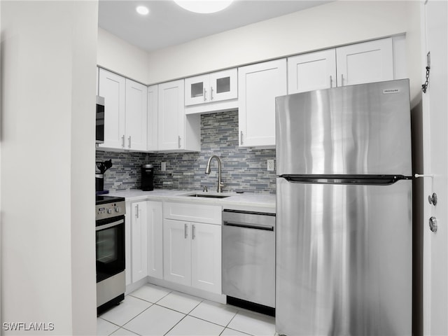 kitchen with tasteful backsplash, white cabinetry, appliances with stainless steel finishes, and sink