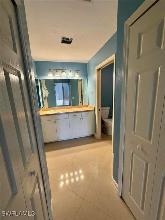 bathroom featuring tile patterned floors, toilet, and vanity