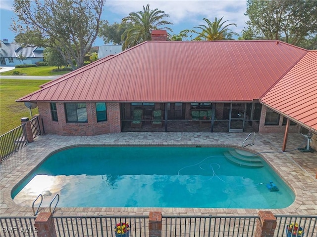 view of pool featuring a patio area and a sunroom