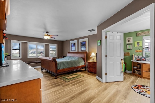 bedroom featuring light hardwood / wood-style floors and ceiling fan