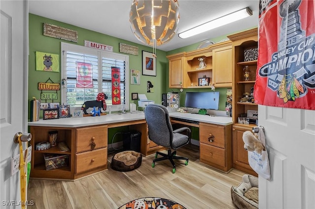 office area with a notable chandelier and light hardwood / wood-style flooring