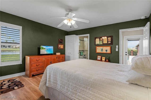 bedroom featuring ceiling fan, connected bathroom, and light wood-type flooring