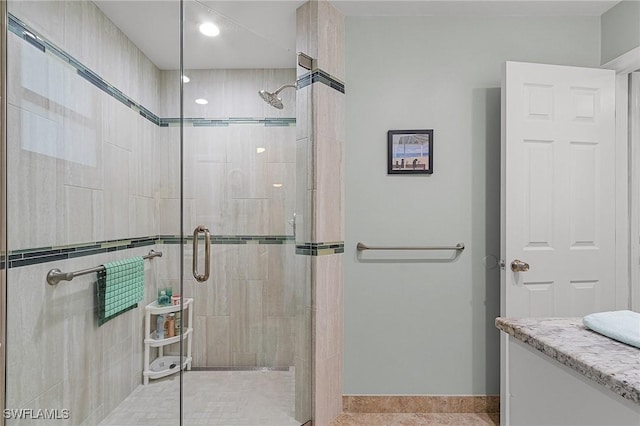 bathroom featuring vanity and a shower with shower door