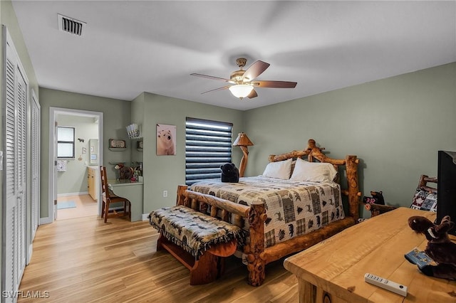 bedroom with connected bathroom, light hardwood / wood-style floors, and ceiling fan