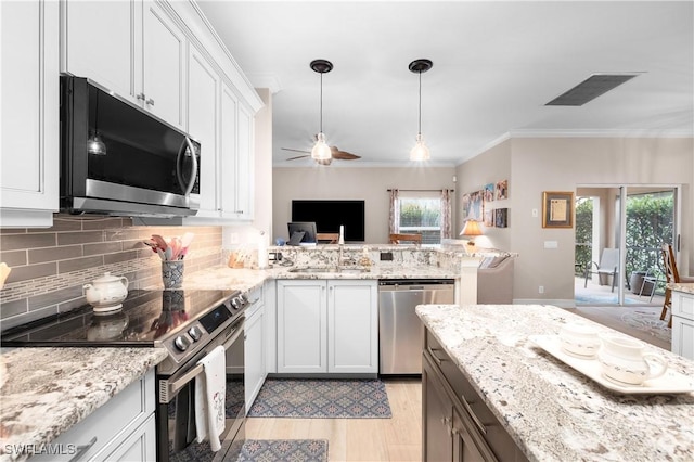 kitchen featuring white cabinetry, sink, a wealth of natural light, and stainless steel appliances