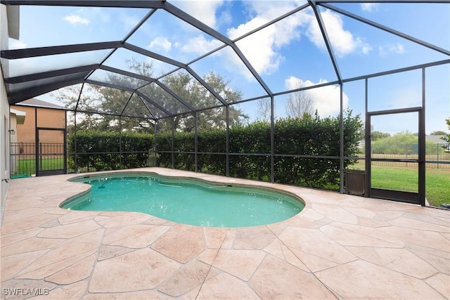 view of swimming pool with a lanai and a patio